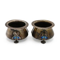 A pair of Elizabeth II silver and enamel salt cellars, of cauldron design and each on outstretche...