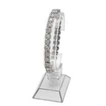 A 14k white gold and diamond bracelet, set with twenty-nine round brilliant cut diamonds within b...