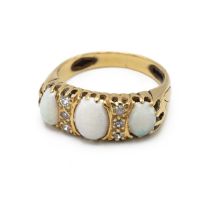 A 1960s 18ct yellow gold opal and diamond ring, in the Victorian style, set with three oval caboc...