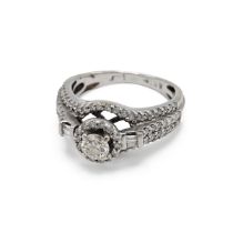 A 14k white gold and diamond dress ring, set with a round brilliant cut diamond approximately 0.3...