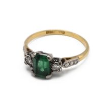 An 18ct yellow gold emerald and diamond ring, the rectangular mixed cut emerald approximately 7mm...
