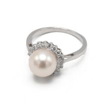 A 9k white gold cultured pearl and diamond dress ring, the 8.8mm pearl set within a border of rou...