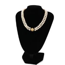 A double row string of cultured pearls, of uniform size approximately 6mm, with a 14k yellow gold...