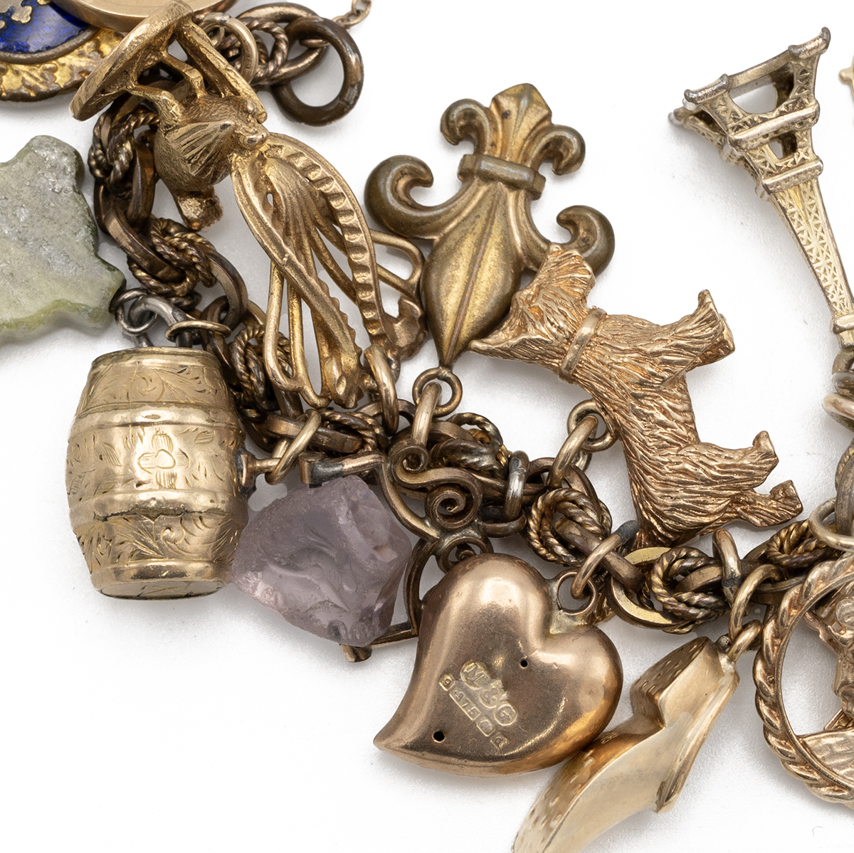 A gilt metal charm bracelet, set with a 9ct gold padlock charm along with various other 9ct, 18ct... - Image 2 of 4