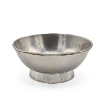 An Elizabeth II silver hammered bowl, with a raised outline border and standing on a circular ped...