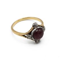 A 19th century yellow gold garnet and diamond ring, the round cabochon garnet with old cut diamon...