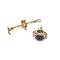 A 9ct gold bar brooch with seated pixie, along with a 9ct gold swivel fob seal. total weight 7.77...