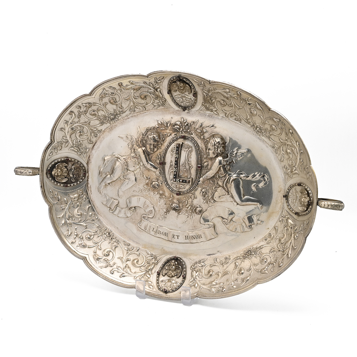 A 19th century silver Hungarian marriage tray, decorated in relief with winged cherubs, the styli...