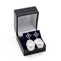 A pair of 18k white gold and baroque pearl drop earrings, the quatrefoil posts set with a single ...