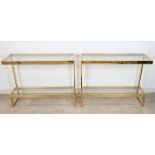 Pair of MCM gilt metal consoles, possibly Italian. 'G' shaped metal frame with glass upper and lo...