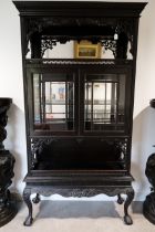 Chinese inspired tall china display cabinet with ebonised finish c1880's. Dragons claw cabriole l...