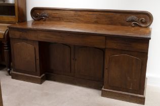 William IV mahogany inverted pedestal sideboard with carved backrail. Right hand pedestal contain...