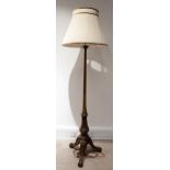 An Edwardian walnut standard lamp, with turned column to carved downswept and scroll footed tripo...