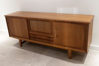 Mid century Danish teak sideboard c1960s. Central drop down front drinks cabinet fitted with manu...