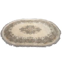 Indian oval rug, muted tones of cream, green and browns with floral details, knotted edge. W 197c...