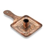 Newlyn copper chamber stick of square form with hand beaten pattern depicting two fish, with a pl...