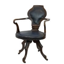 Late 19th century mahogany swivel desk chair. wide seat with sweeping arms, shield shaped back an...