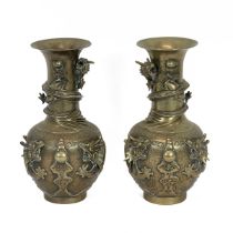 Pair of Chinese late 19th/early 20th Century brass vases heavily decorated with four toed dragons...