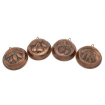 Set of four copper moulds for tarts with repousse patterns for fruit and vegetables each 14cm dia...