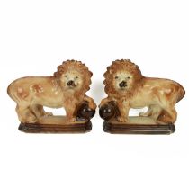 Pair of Staffordshire Lions with paws raised on globes. Height 18cm, Width 33cm. (2) (M)