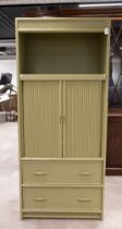 Vintage American media cabinet. Wooden frame with central rolling front doors, two rattan-fronted...