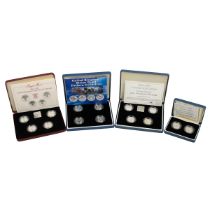 Four (4) silver proof Royal Mint £1 coin collectors sets. Includes (1) 1984-1987 National flowers...