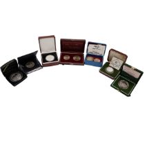 Seven (7) silver world coins and sets in presentation packaging. Includes (1) 1973 Turkey 50th An...