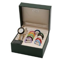 Gucci change bezel gold plated wrist watch with white dial, in green leather box, with 12 bezels.