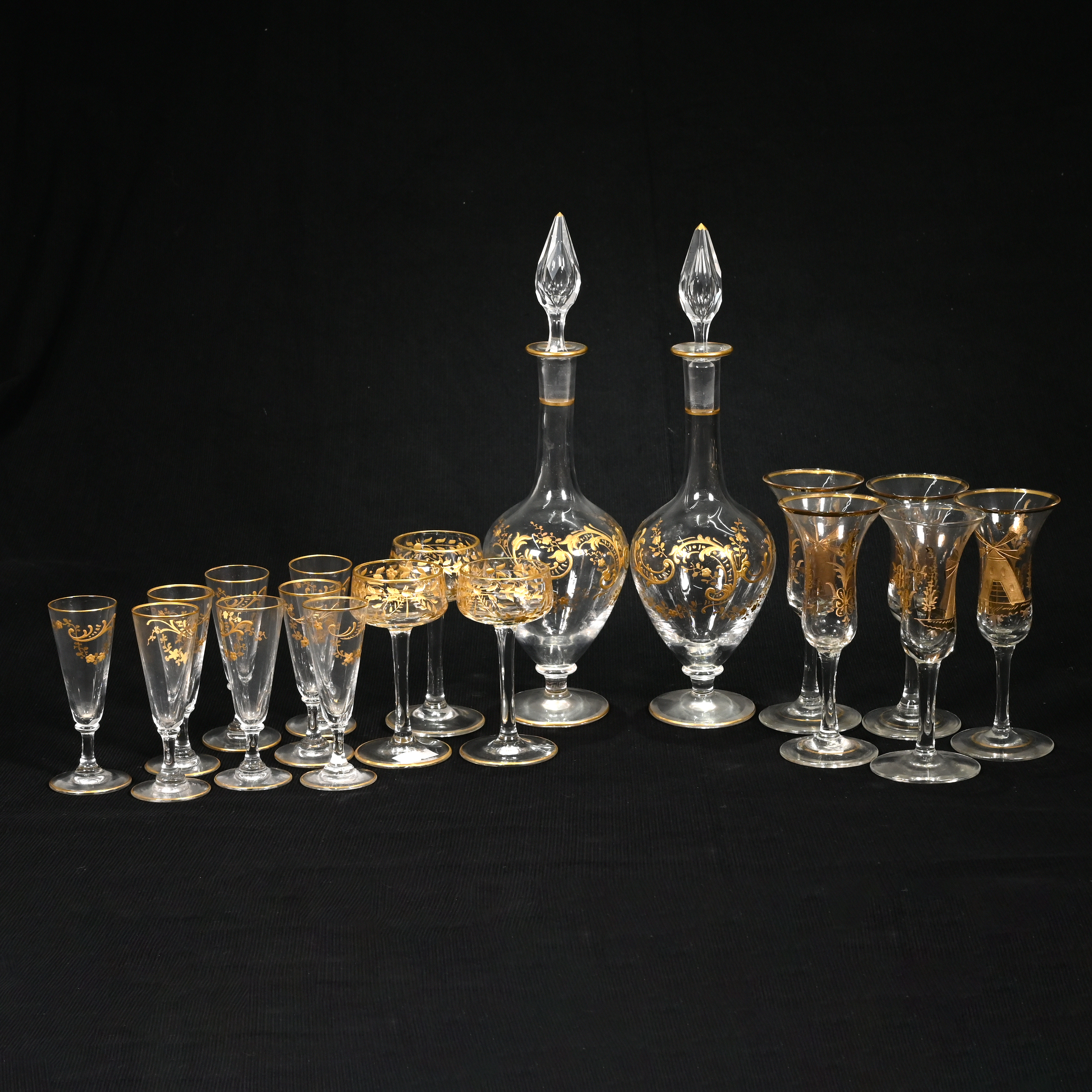 A pair of slender teardrop shaped 19th century continental liqueur or cordial decanters with gilt...