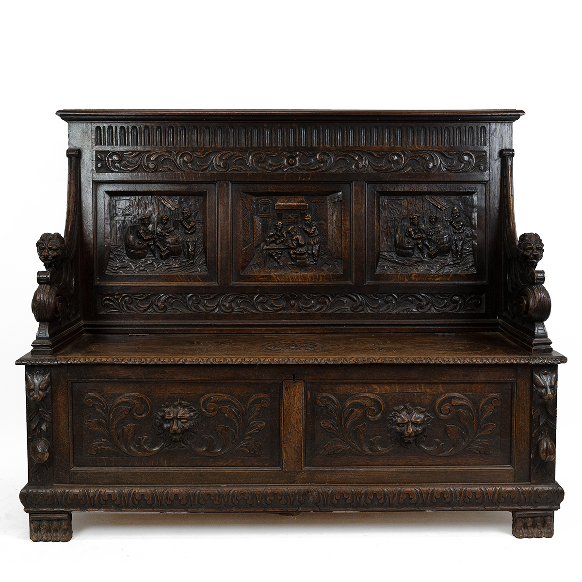 Late 19th Century Flemish oak settle, heavily carved throughout. The back with three inset fielde...