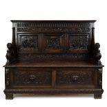 Late 19th Century Flemish oak settle, heavily carved throughout. The back with three inset fielde...