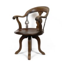 Mid Victorian elm and beech swivel office chair with slatted back the lyre shaped slats pierced w...