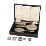 A collection of five silver vesta cases, various dates and makers, and a silver-backed dressing t...