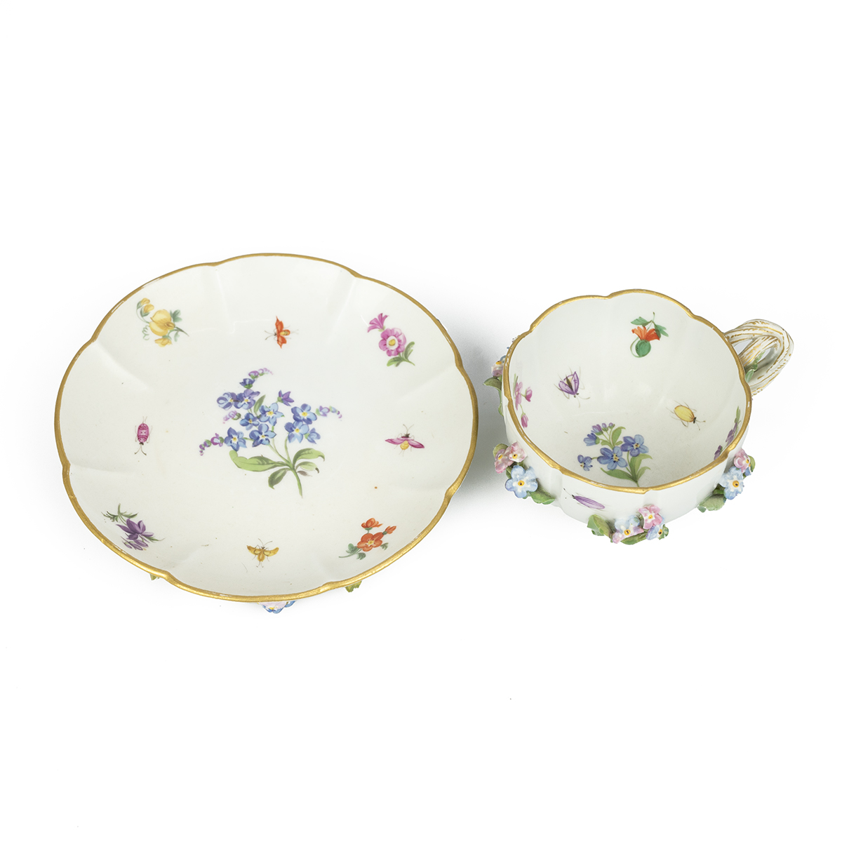 A 19th Century "Flowers and Bugs" tea cup and saucer encrusted with flowers, bearing the Meissen ...