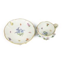 A 19th Century "Flowers and Bugs" tea cup and saucer encrusted with flowers, bearing the Meissen ...
