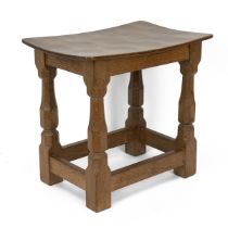 Robert Mouseman Thompson, Kilburn: An English Oak Stool, with a solid top, on four octagonal legs...