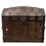 19th Century iron bound oak domed top trunk the leathered panelled lid opening to reveal a paper ...