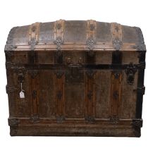 19th Century iron bound oak domed top trunk the leathered panelled lid opening to reveal a paper ...