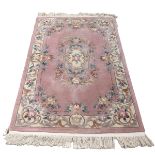 Thick wollen rug in pink, lilac and cream tones. L 210cm, W 121cm.
