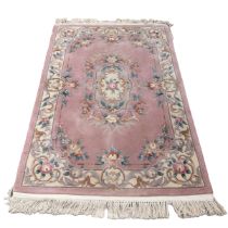 Thick wollen rug in pink, lilac and cream tones. L 210cm, W 121cm.