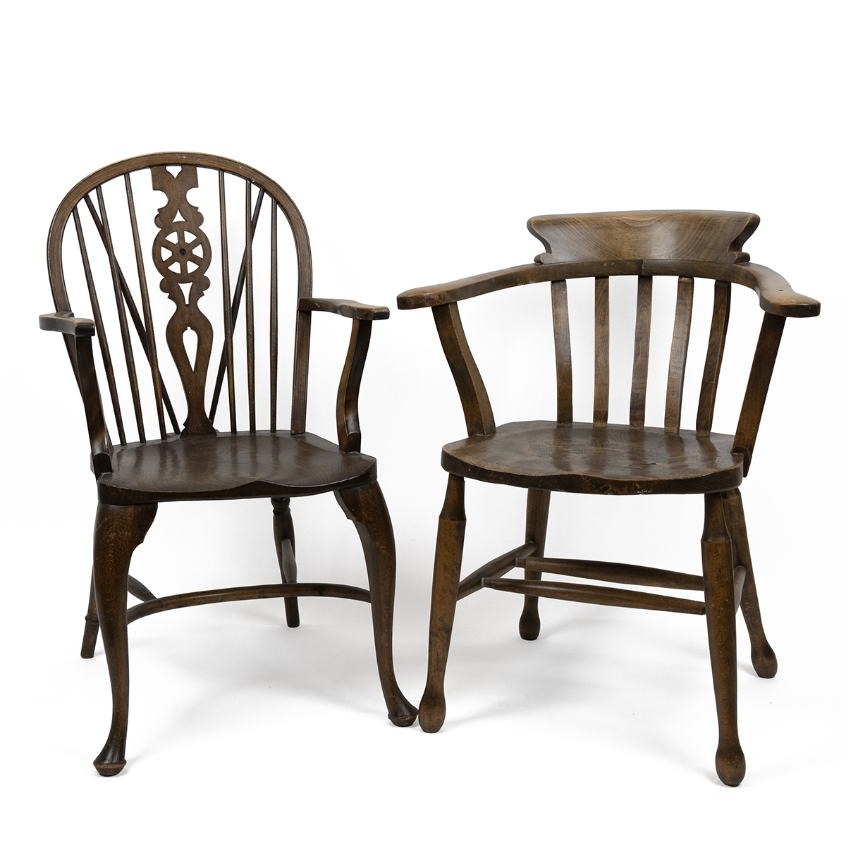 Early 20th Century country arm chairs to include a Captain's chair in elm and beach of usual form...