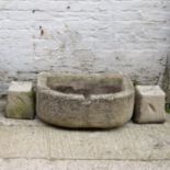 Antique stone water trough raised on two square stones. W 75cm, D 48cm, H 57cm.