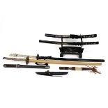 Collection of four reproduction collector samurai swords, the grip decorated with various figures...