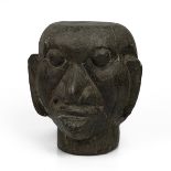 A 20th-century solid carved wooden tribal ancestor head, 25cm high, 23cm wide.