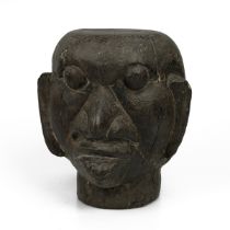 A 20th-century solid carved wooden tribal ancestor head, 25cm high, 23cm wide.