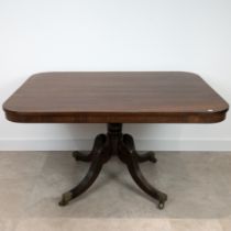 Regency mahogany breakfast table with rectangular tilt top. Sweeping legs with fluted tops, on ca...