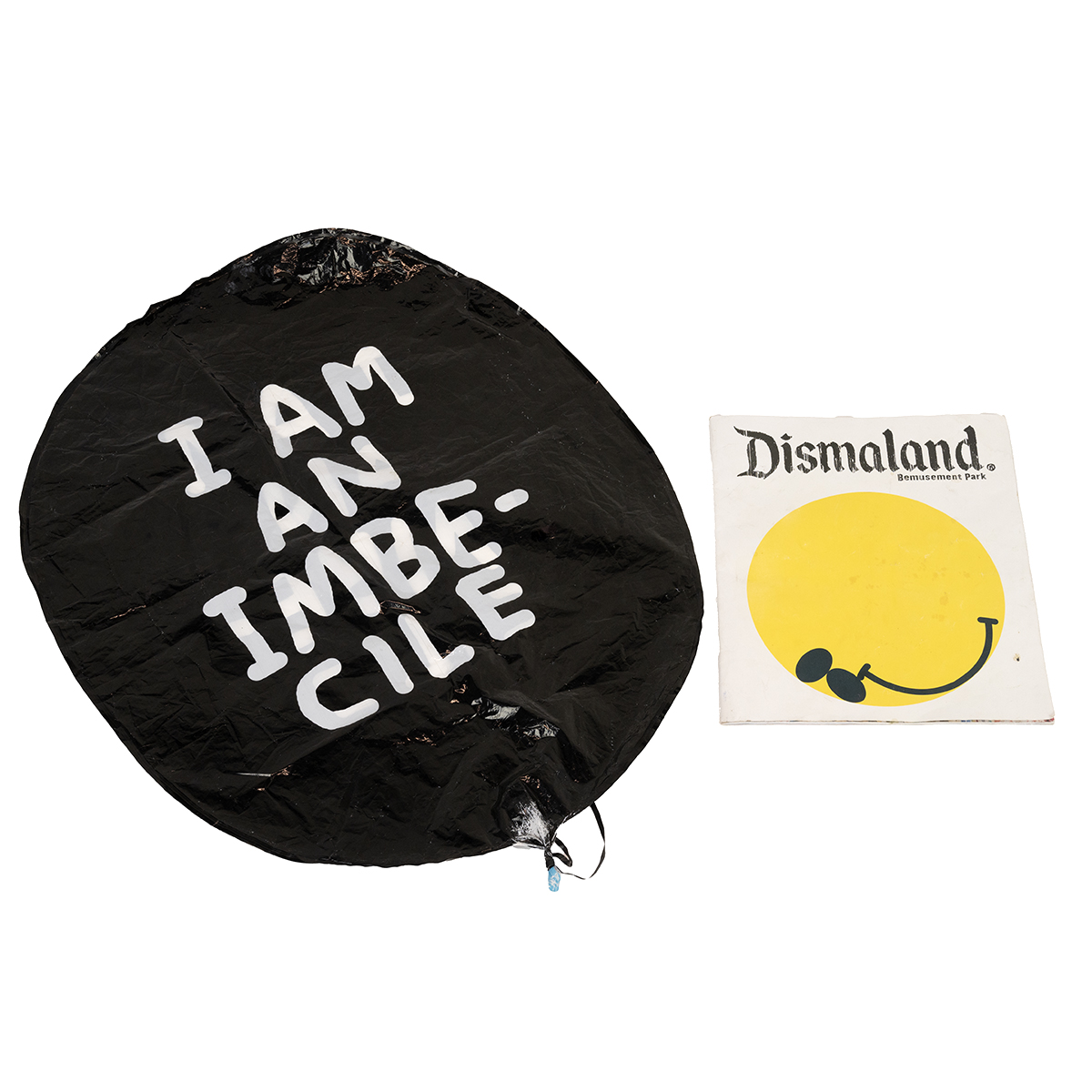 Banksy (B. 1974), "I am an imbecile" balloon, 90 x 60 cm, along with a Dismaland souvenir programme.