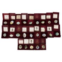 Collection of 23 Staffordshire hand painted enamel pill boxes from the Allied Dunbar Collection d...