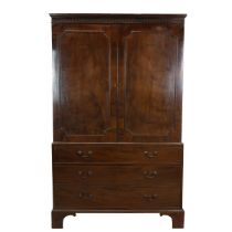 Georgian flame mahogany linen press, three drawers, with swan neck brass handles below cabinet wi...