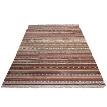 Vintage kilim rug, hand-knotted with a multi-coloured ground, with repeating patterns throughout....